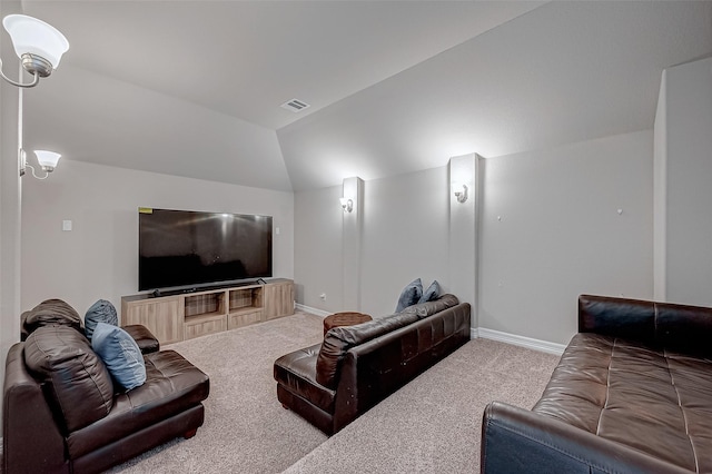 carpeted home theater featuring lofted ceiling