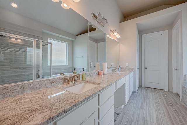 bathroom with vanity and separate shower and tub