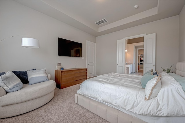 carpeted bedroom featuring a raised ceiling