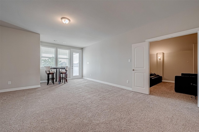 spare room featuring light colored carpet