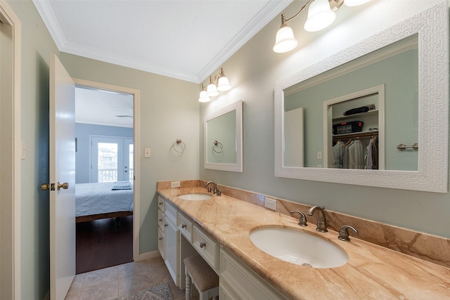 bathroom featuring vanity, ornamental molding, and tile patterned flooring