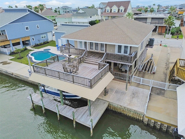 rear view of property featuring central air condition unit, a patio area, and a pool side deck with water view