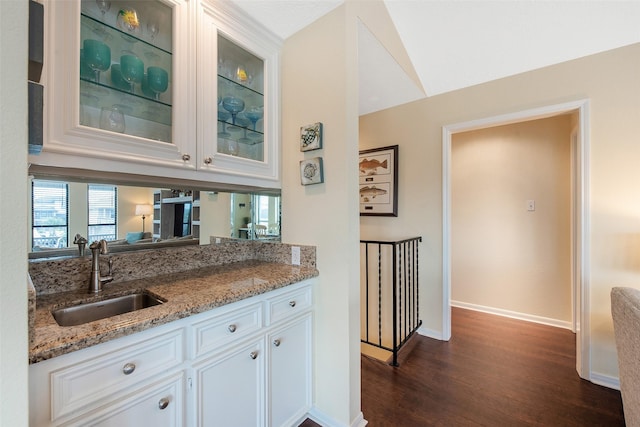 bar featuring sink, dark hardwood / wood-style floors, white cabinets, and light stone countertops