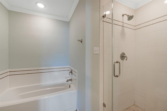 bathroom featuring ornamental molding and shower with separate bathtub