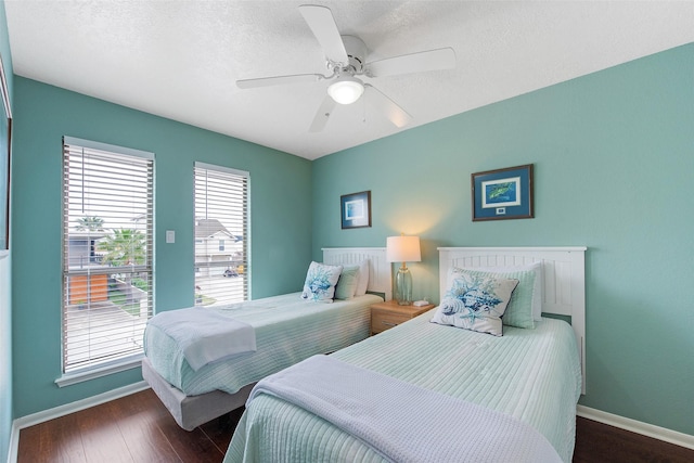 bedroom with ceiling fan and dark wood-type flooring