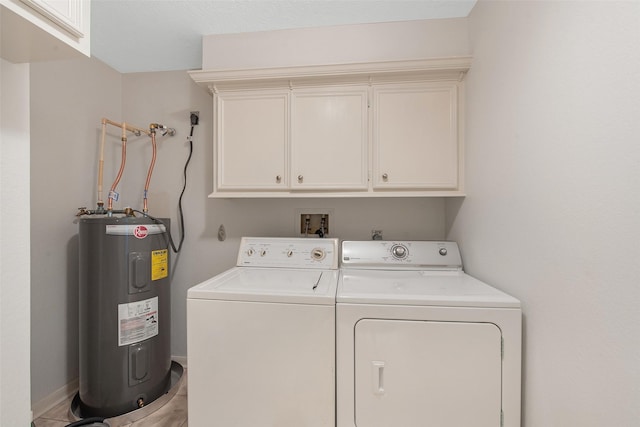 laundry area with washing machine and clothes dryer, cabinets, and electric water heater