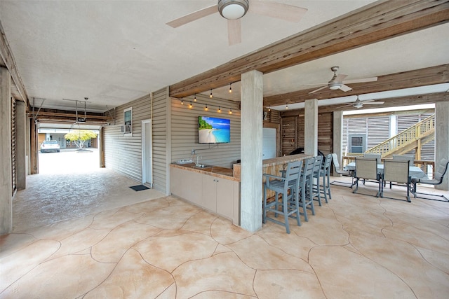 view of patio / terrace with ceiling fan and exterior bar