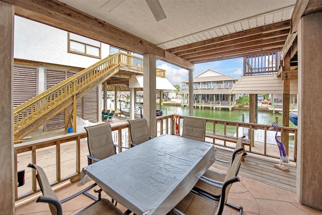 exterior space with ceiling fan and a water view