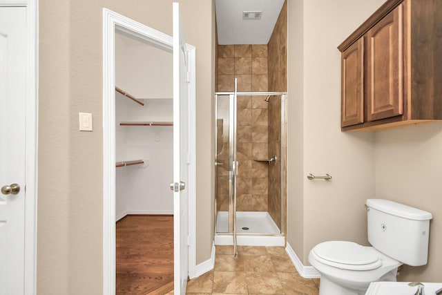 bathroom with toilet and walk in shower