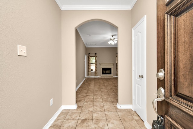 corridor featuring light tile patterned floors and ornamental molding