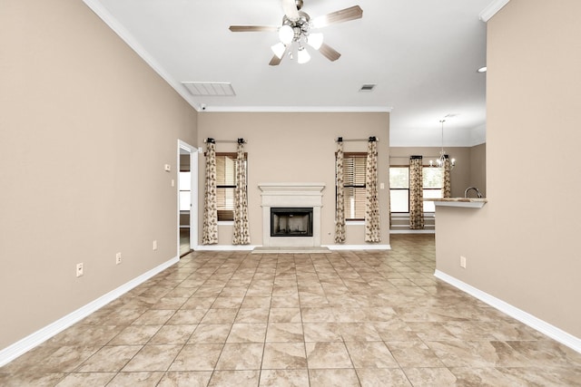 unfurnished living room featuring ceiling fan with notable chandelier, light tile patterned floors, and ornamental molding