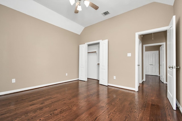 unfurnished bedroom with a closet, ceiling fan, dark hardwood / wood-style flooring, and lofted ceiling