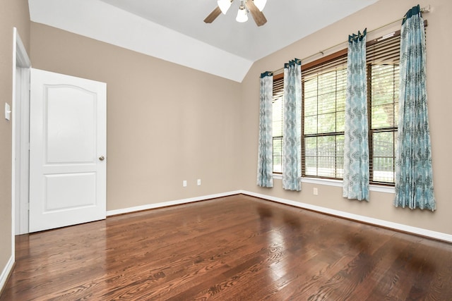 spare room featuring ceiling fan, a wealth of natural light, hardwood / wood-style floors, and lofted ceiling