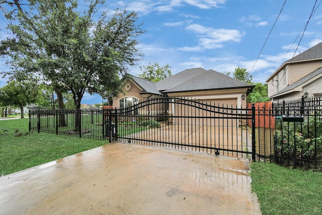 view of gate featuring a garage and a yard