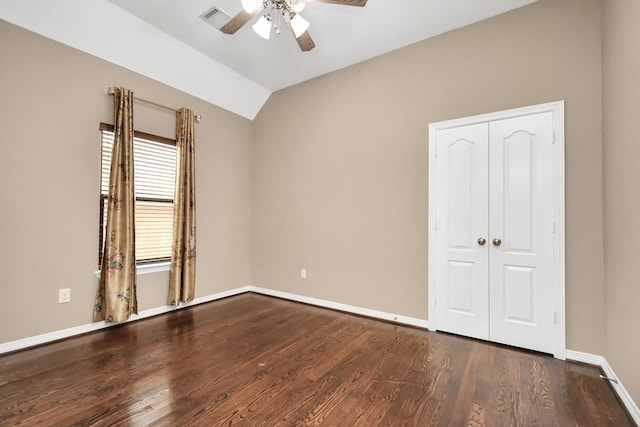 unfurnished bedroom featuring a closet, vaulted ceiling, ceiling fan, and dark hardwood / wood-style flooring