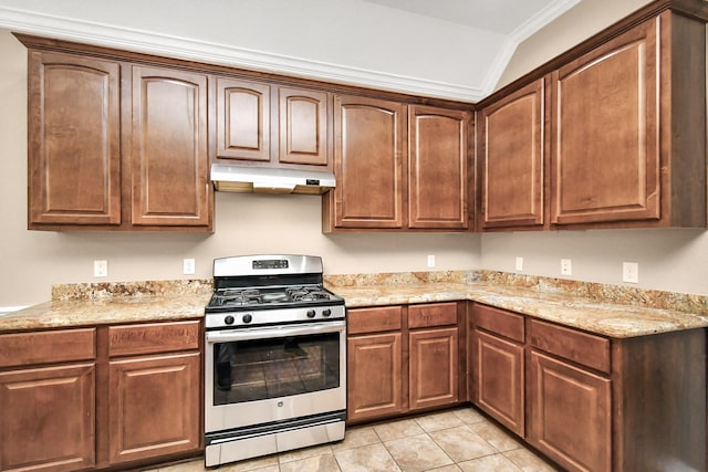 kitchen with light tile patterned flooring, ornamental molding, light stone counters, stainless steel range with gas cooktop, and lofted ceiling