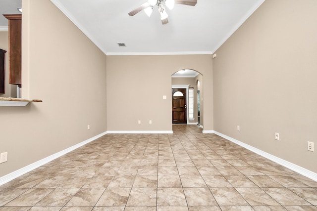 tiled empty room with ceiling fan and ornamental molding