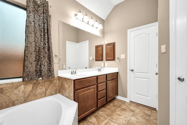 bathroom featuring a tub to relax in, vanity, and lofted ceiling