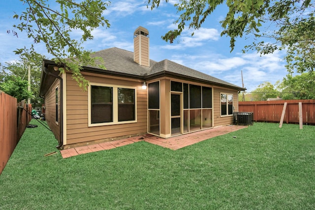 back of house featuring central air condition unit, a lawn, and a patio