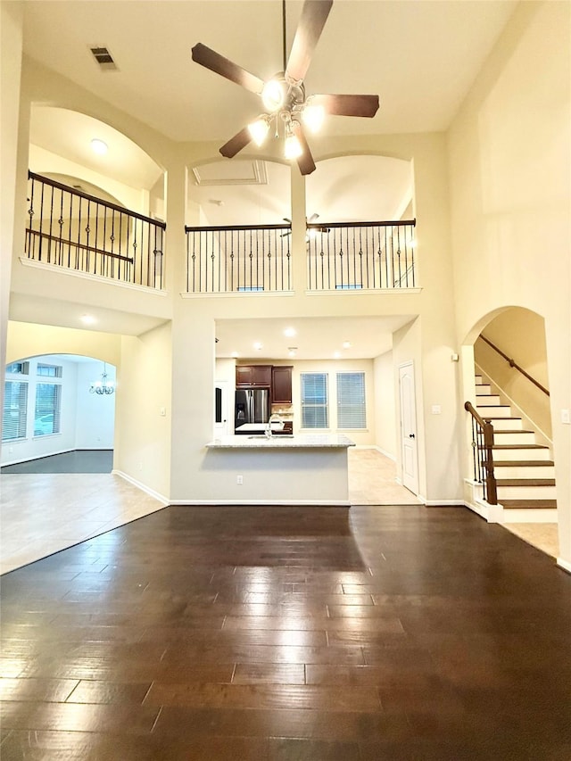 unfurnished living room featuring wood-type flooring and ceiling fan