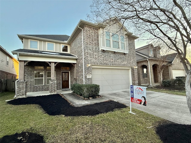 view of front of home featuring a porch, a garage, and a front yard