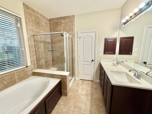 bathroom featuring vanity, tile patterned flooring, and independent shower and bath