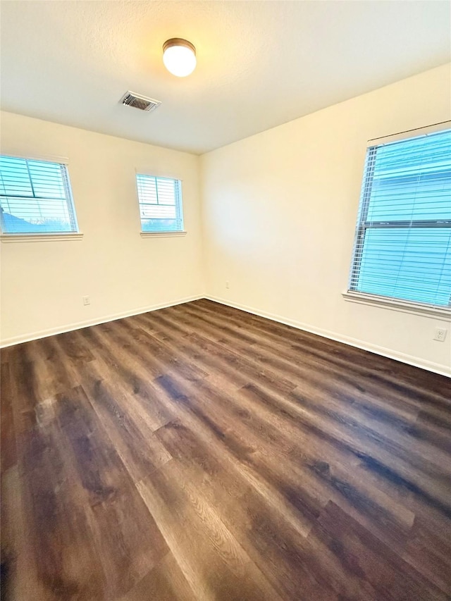 empty room featuring dark wood-type flooring