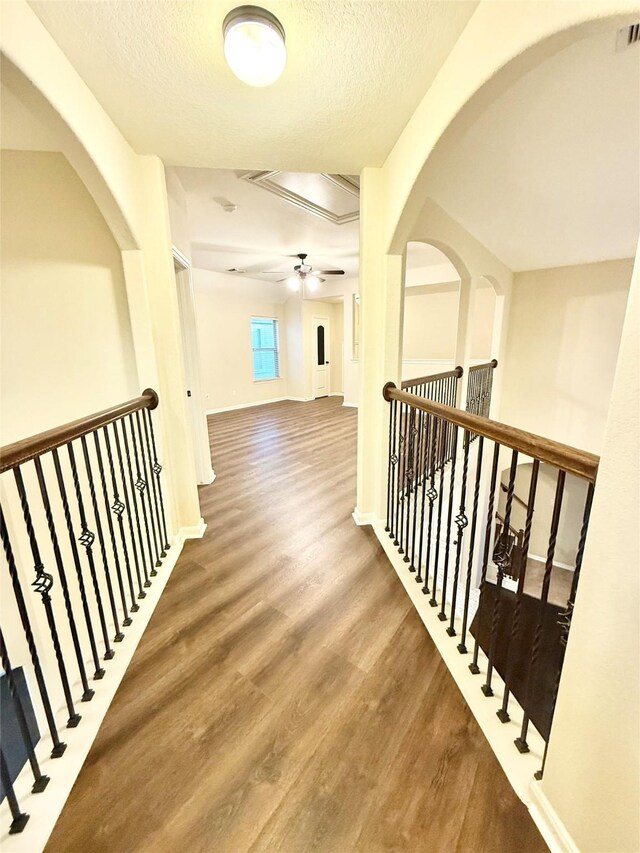 hallway featuring hardwood / wood-style floors and a textured ceiling