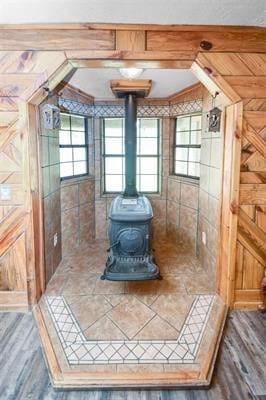 interior space with a wood stove and hardwood / wood-style floors