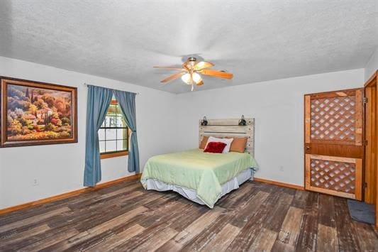 bedroom featuring ceiling fan, dark wood-type flooring, and a textured ceiling