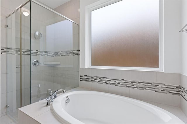 bathroom featuring separate shower and tub