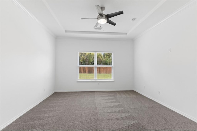 carpeted spare room featuring crown molding, ceiling fan, and a tray ceiling