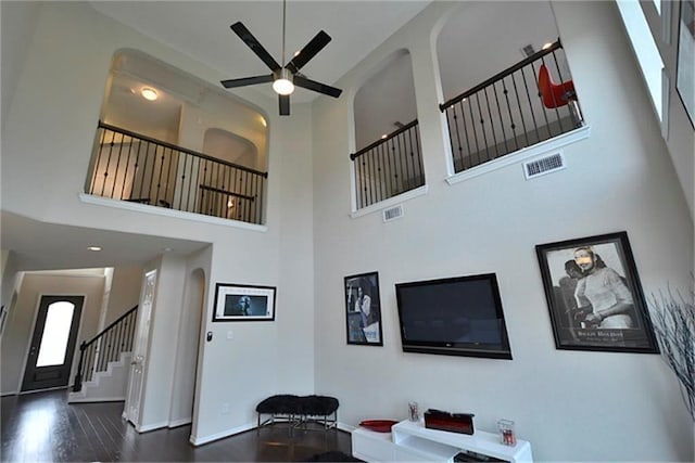 living room with dark hardwood / wood-style floors and ceiling fan