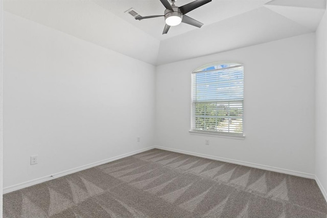 empty room featuring lofted ceiling, carpet floors, and ceiling fan