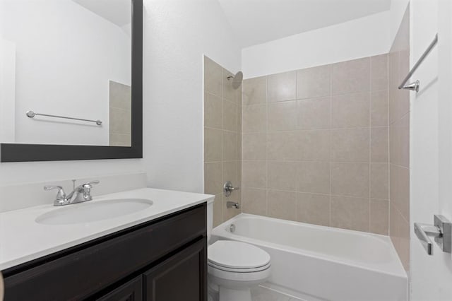 full bathroom with tiled shower / bath combo, vanity, and toilet