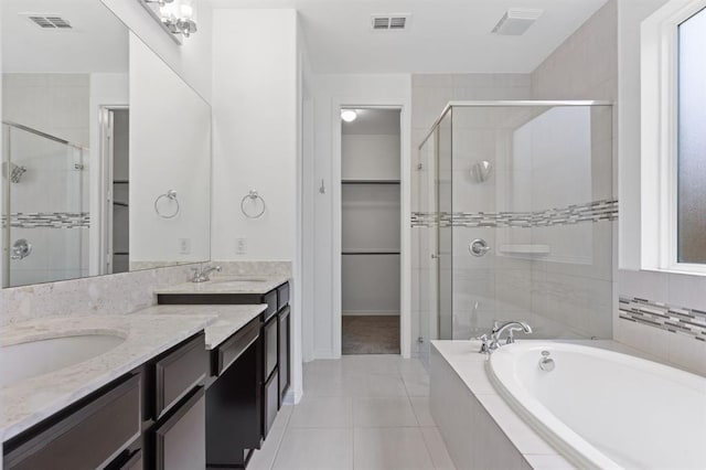 bathroom with vanity, plus walk in shower, and tile patterned flooring