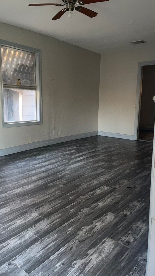 unfurnished room with ceiling fan and dark hardwood / wood-style flooring