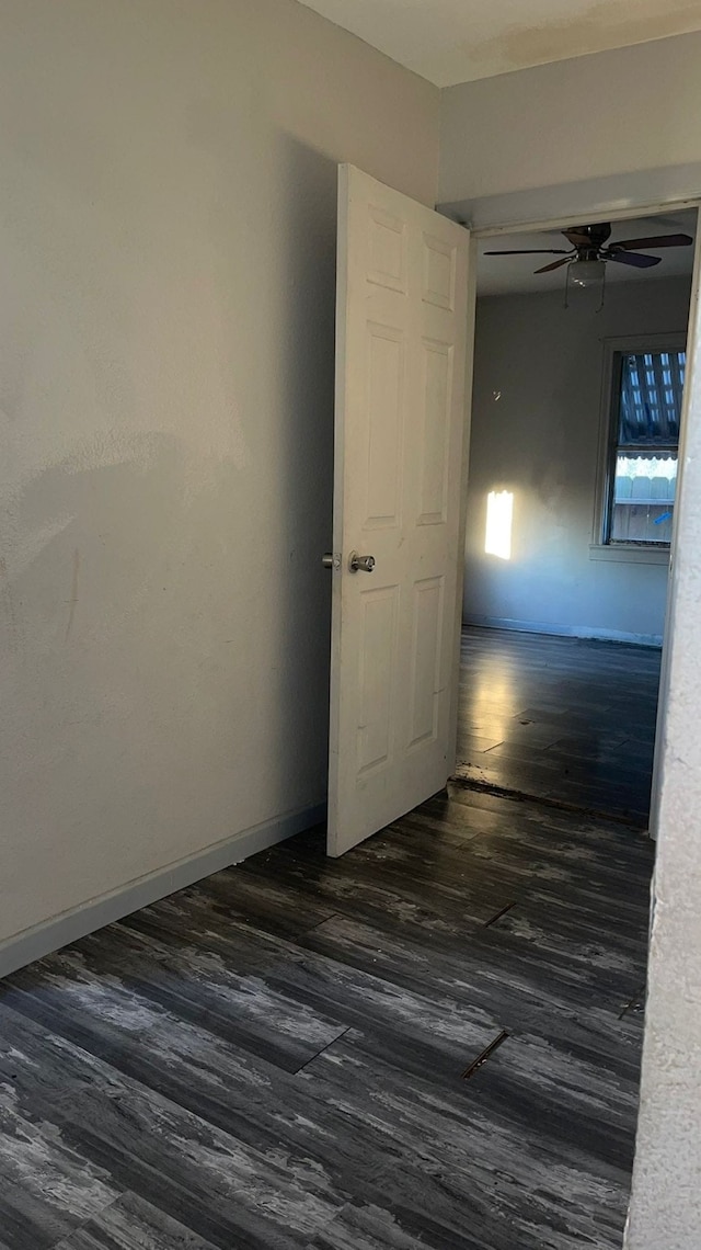 spare room with ceiling fan and dark hardwood / wood-style floors