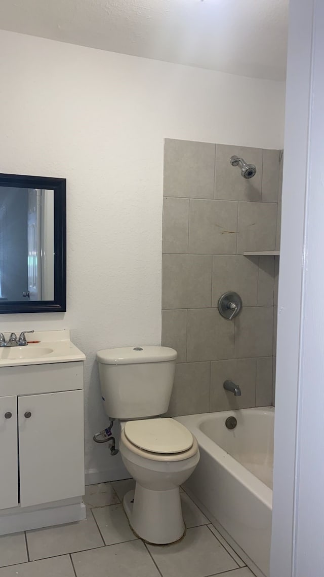 full bathroom with toilet, tiled shower / bath, tile patterned floors, and vanity