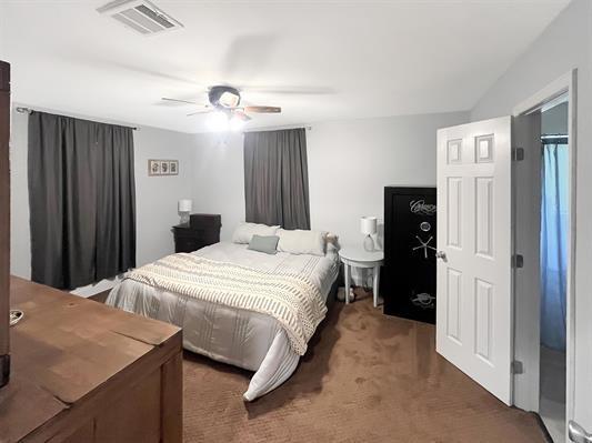 carpeted bedroom with ceiling fan