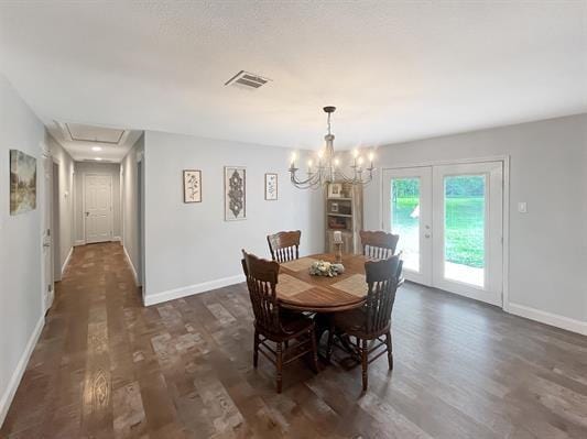 dining room featuring a chandelier, french doors, and dark hardwood / wood-style floors