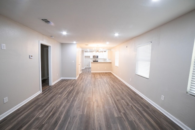 unfurnished living room with dark hardwood / wood-style flooring