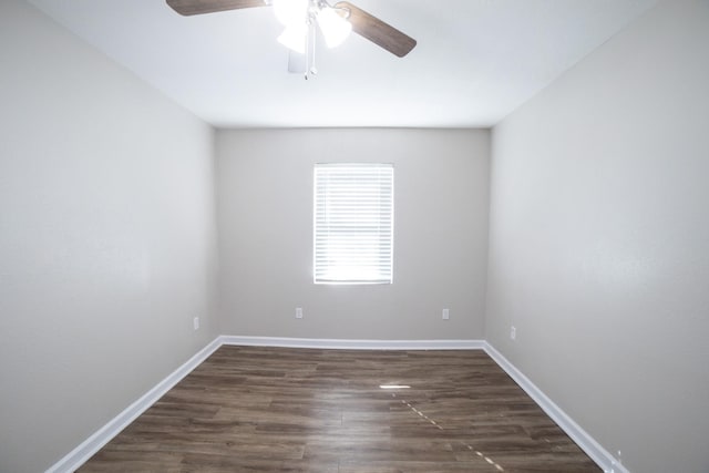 spare room featuring dark wood-type flooring and ceiling fan