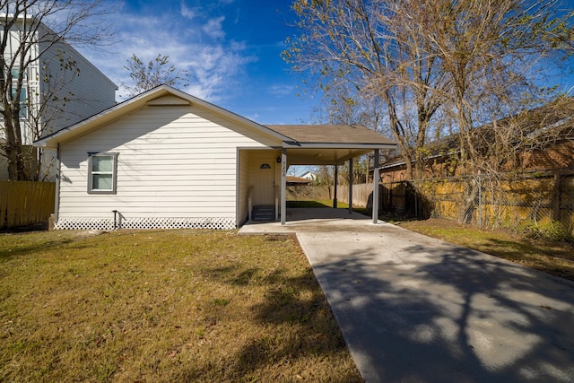 view of property exterior with a carport and a yard