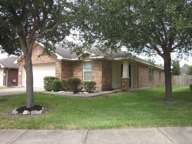 single story home with a garage and a front yard