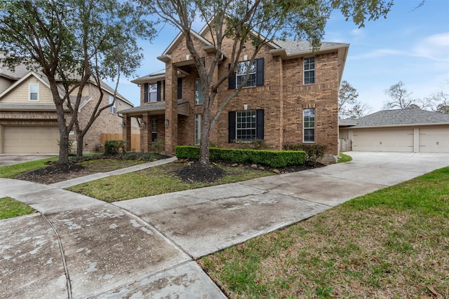 townhome / multi-family property featuring a garage and a front lawn