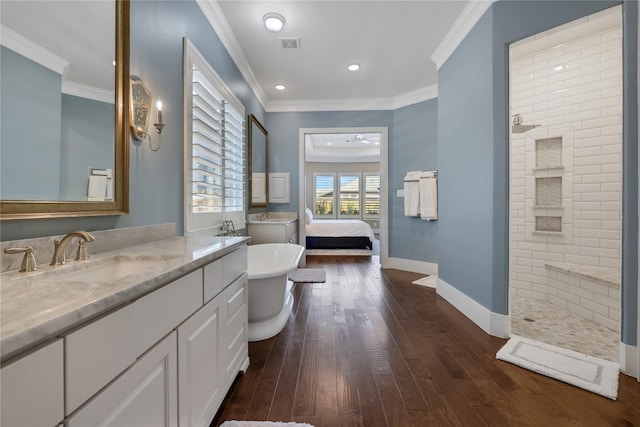 bathroom featuring hardwood / wood-style flooring, ceiling fan, vanity, ornamental molding, and separate shower and tub