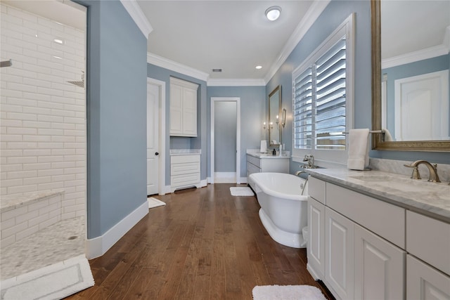 bathroom with vanity, hardwood / wood-style flooring, ornamental molding, and shower with separate bathtub