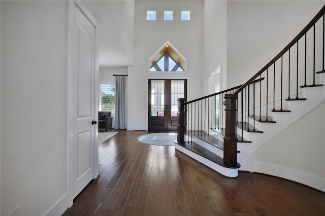 entryway featuring french doors, dark hardwood / wood-style floors, and a high ceiling