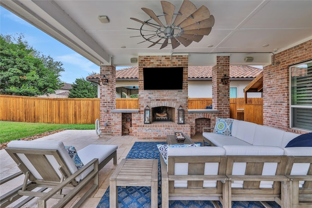 view of patio featuring ceiling fan and an outdoor living space with a fireplace